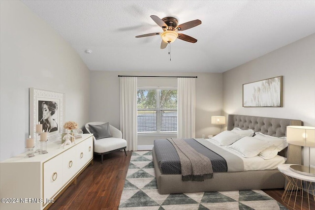 bedroom featuring ceiling fan, a textured ceiling, vaulted ceiling, and dark hardwood / wood-style floors