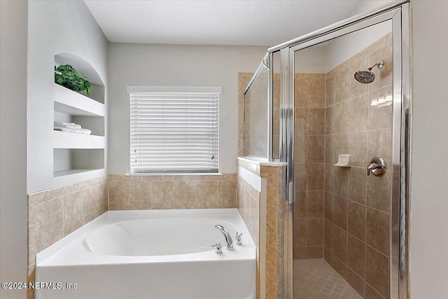 bathroom with a textured ceiling and plus walk in shower