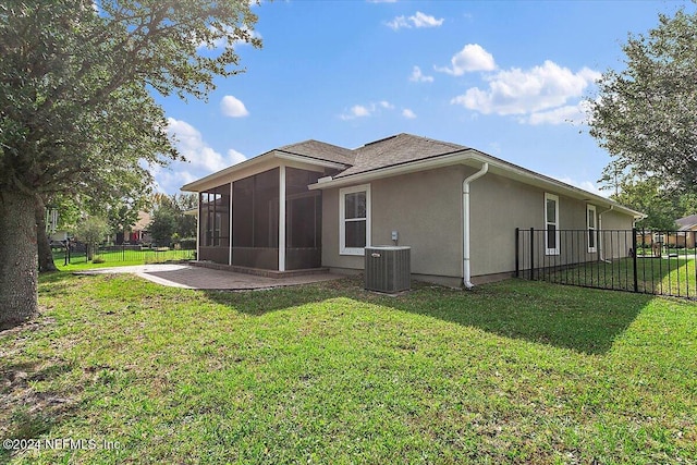 rear view of house with a patio, cooling unit, a lawn, and a sunroom