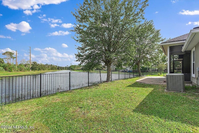 view of yard featuring a deck and central AC unit