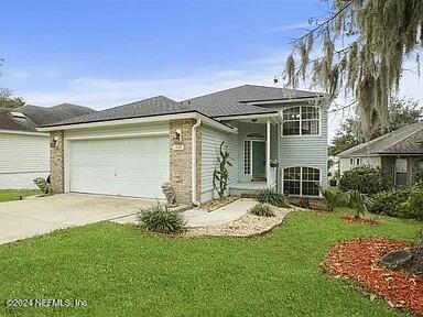 view of front of house with a front yard and a garage