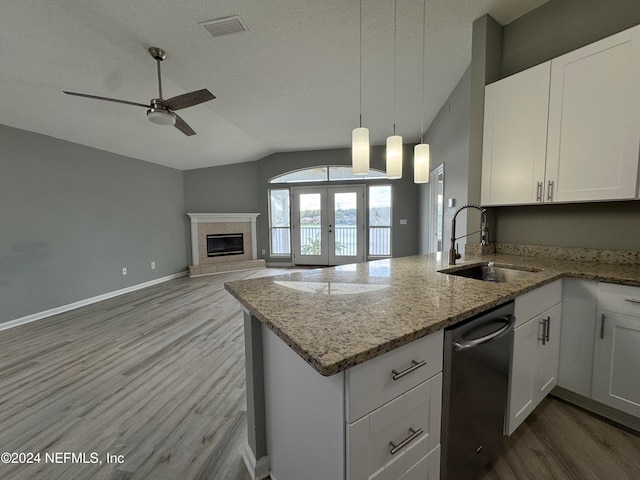 kitchen with light hardwood / wood-style floors, white cabinets, sink, and vaulted ceiling