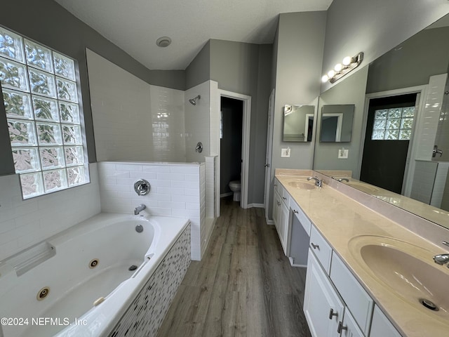 full bathroom featuring toilet, vanity, independent shower and bath, and wood-type flooring