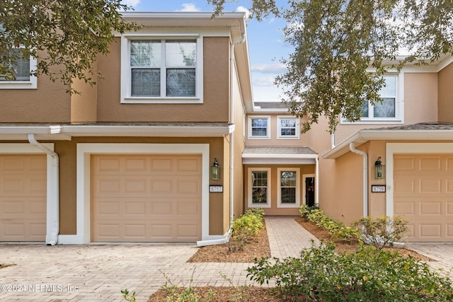 8757 Little Swift Cir Unit 22F, Jacksonville, FL 32256 - multi unit property featuring stucco siding, driveway, and a garage