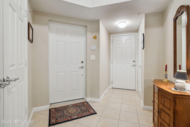 8757 Little Swift Cir Unit 22F, Jacksonville, FL 32256 - foyer with light tile patterned floors and baseboards