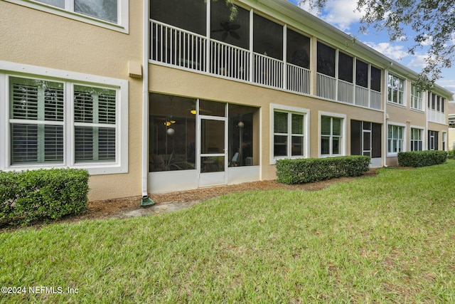 8757 Little Swift Cir Unit 22F, Jacksonville, FL 32256 - back of house featuring stucco siding and a lawn