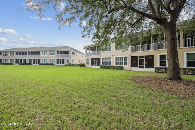 8757 Little Swift Cir Unit 22F, Jacksonville, FL 32256 - back of property featuring a lawn and stucco siding