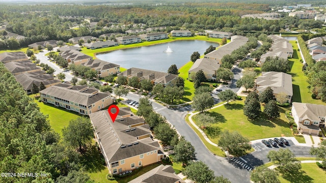 drone / aerial view featuring a water view and a residential view