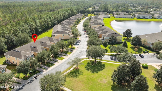 birds eye view of property featuring a water view and a residential view