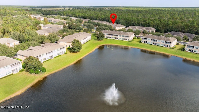 birds eye view of property featuring a forest view and a water view