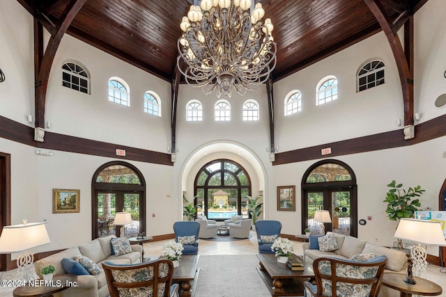 tiled living room with a chandelier, wood ceiling, french doors, and arched walkways