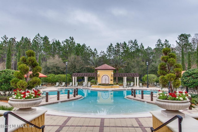 view of pool with a patio and a pergola