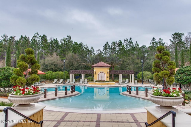 8757 Little Swift Cir Unit 22F, Jacksonville, FL 32256 - community pool with a pergola, a patio area, and view of wooded area