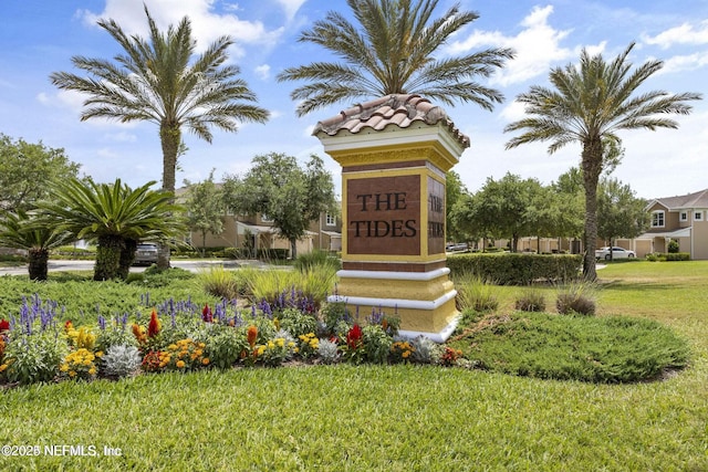 community / neighborhood sign with a lawn