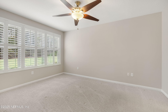 empty room with a ceiling fan, carpet flooring, and baseboards