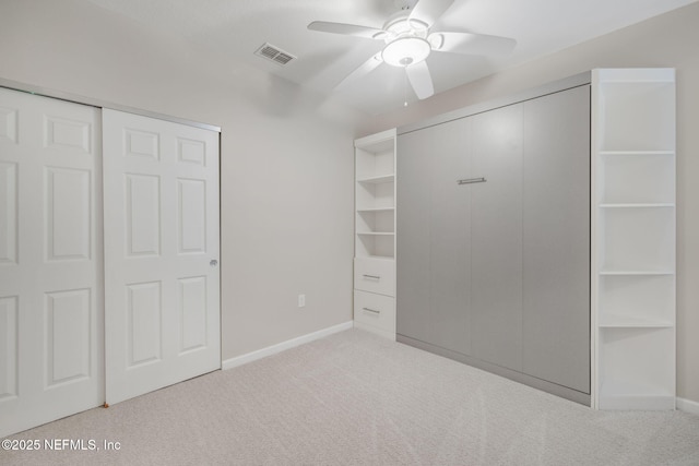 unfurnished bedroom with ceiling fan, carpet flooring, visible vents, and baseboards