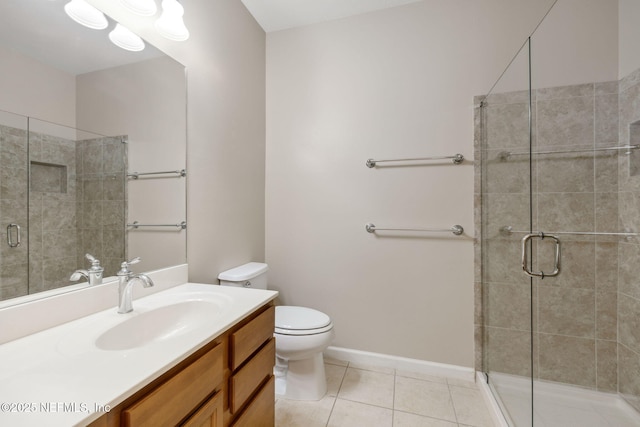 bathroom with vanity, a shower stall, toilet, and tile patterned floors