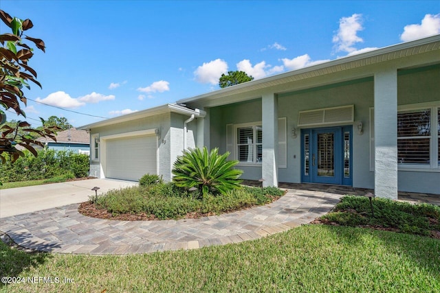 view of front facade with a front yard and a garage