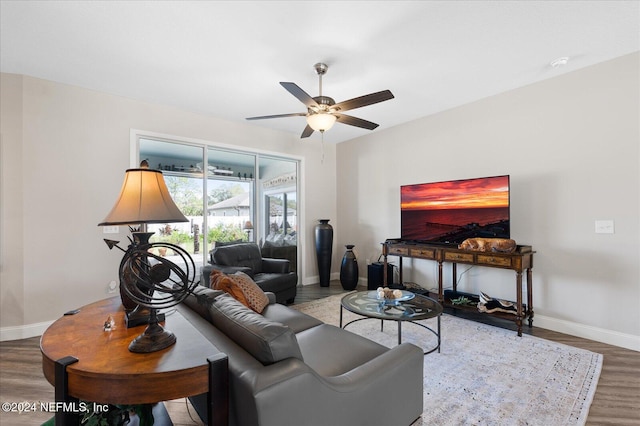 living room featuring ceiling fan and wood-type flooring