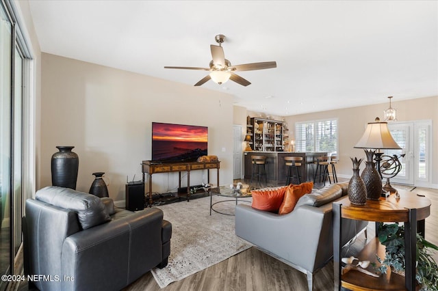 living room featuring hardwood / wood-style flooring and ceiling fan