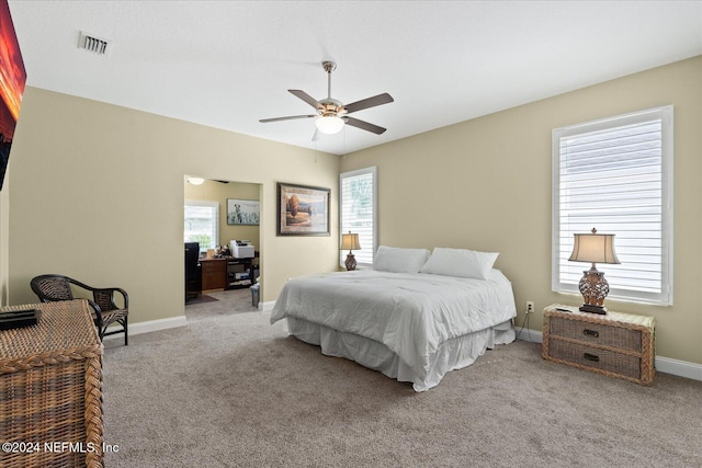 carpeted bedroom with multiple windows and ceiling fan