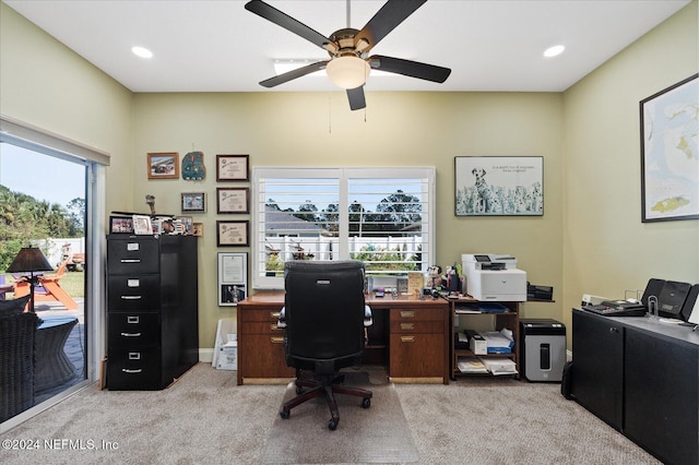 carpeted home office featuring ceiling fan