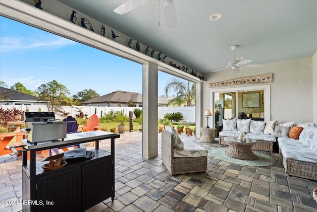 view of patio with an outdoor living space, grilling area, and ceiling fan