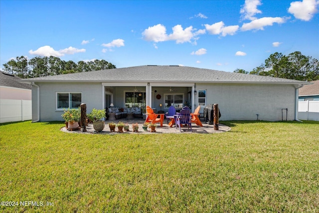 rear view of house with a patio area, a lawn, and ceiling fan