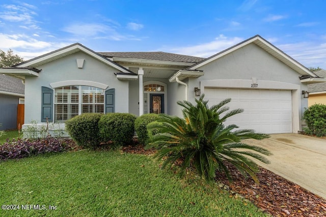 ranch-style house featuring a garage and a front yard