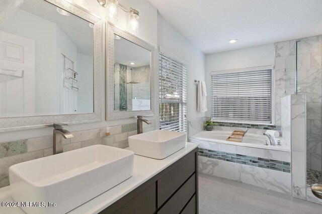 bathroom featuring vanity and plus walk in shower