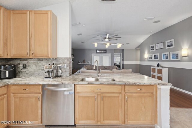 kitchen with kitchen peninsula, sink, stainless steel dishwasher, light wood-type flooring, and light brown cabinetry