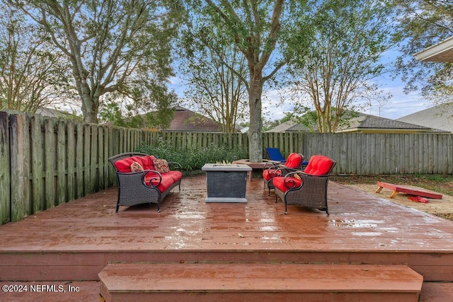 wooden deck featuring an outdoor fire pit