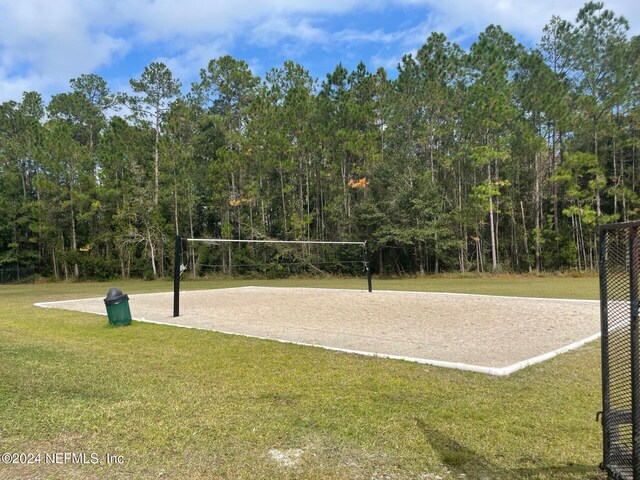 view of community featuring a lawn and volleyball court