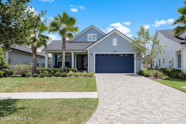 view of front of property with a garage and a front yard