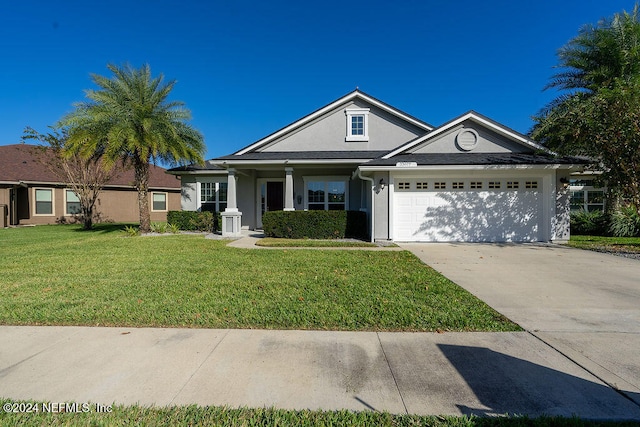 ranch-style house featuring a front yard and a garage