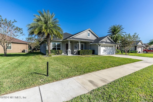 ranch-style home with a front yard, central AC, and a garage