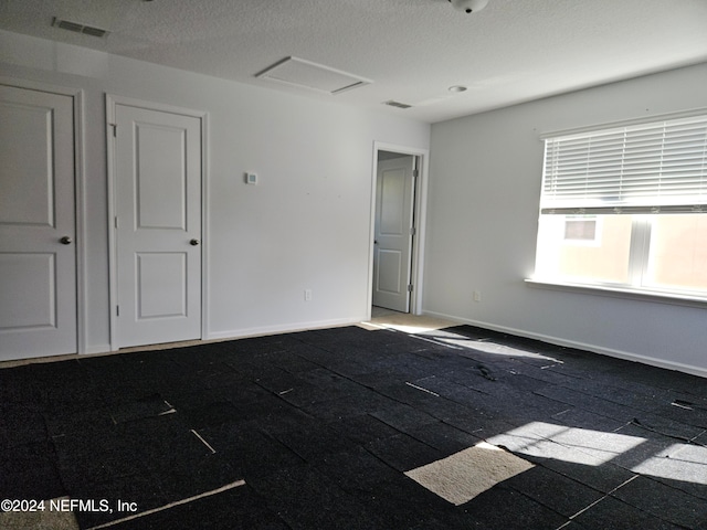 empty room featuring a textured ceiling