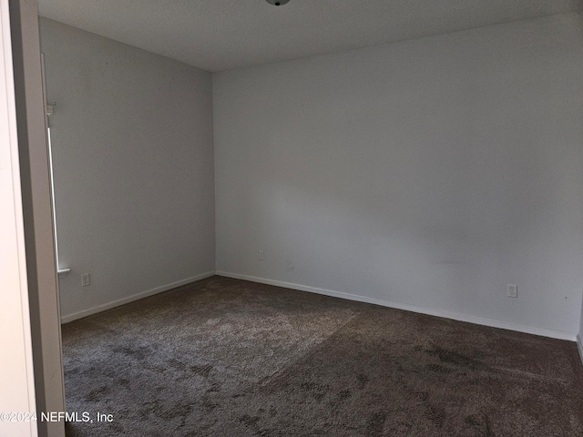 carpeted spare room with a textured ceiling