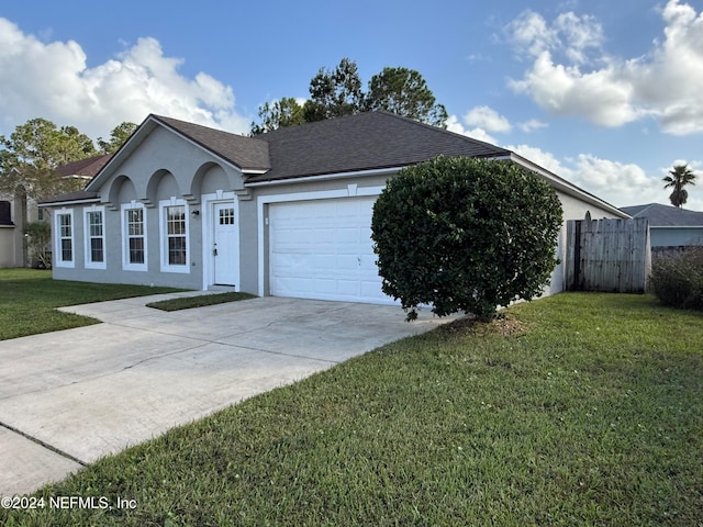 single story home featuring a front lawn and a garage