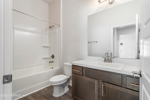 full bathroom with vanity, shower / washtub combination, wood-type flooring, and toilet