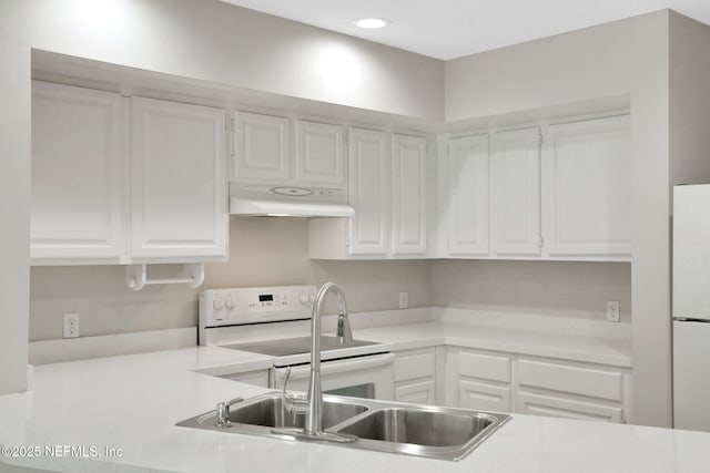 kitchen featuring white appliances and white cabinets