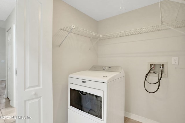 laundry room featuring washer / clothes dryer and light tile patterned floors