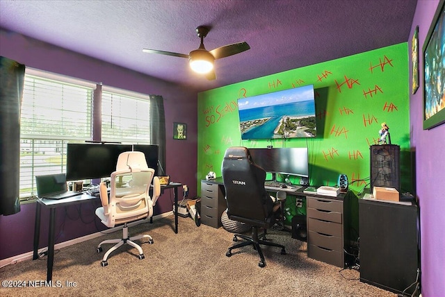 carpeted office featuring ceiling fan and a textured ceiling