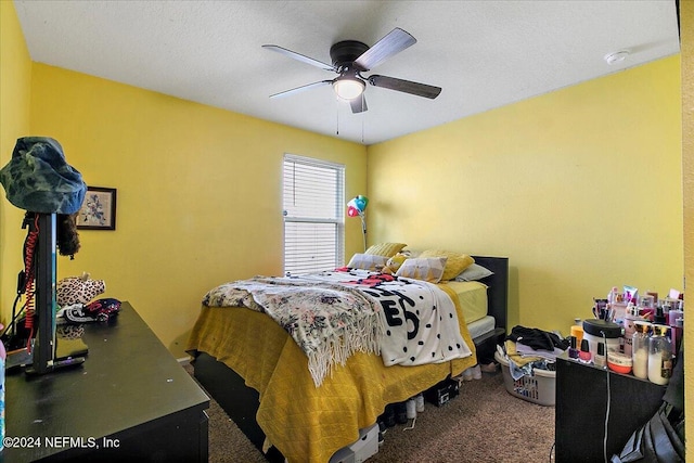 bedroom with ceiling fan and dark colored carpet