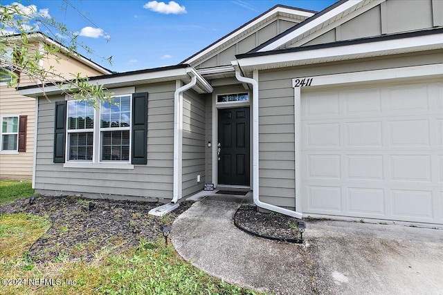 doorway to property featuring a garage