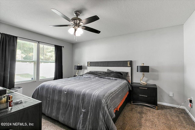 carpeted bedroom with ceiling fan and a textured ceiling