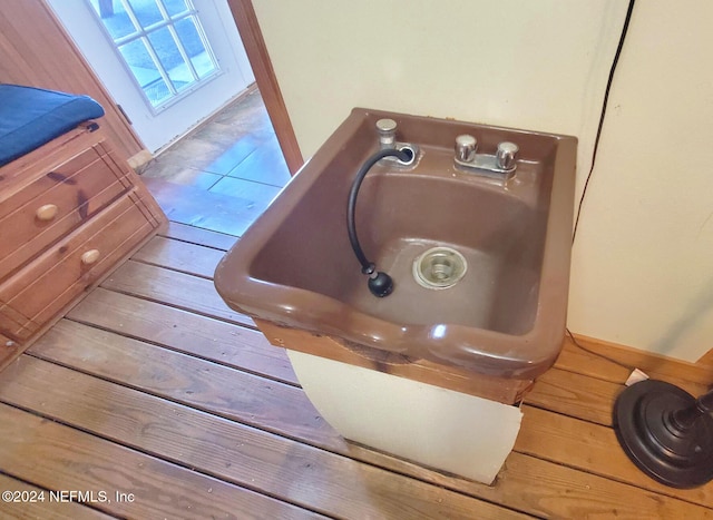 room details featuring hardwood / wood-style flooring and sink