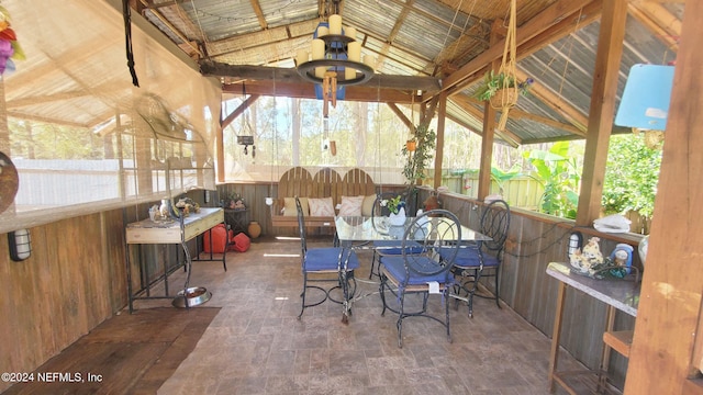 sunroom featuring lofted ceiling