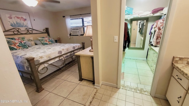 bedroom with ceiling fan, cooling unit, and light tile patterned floors