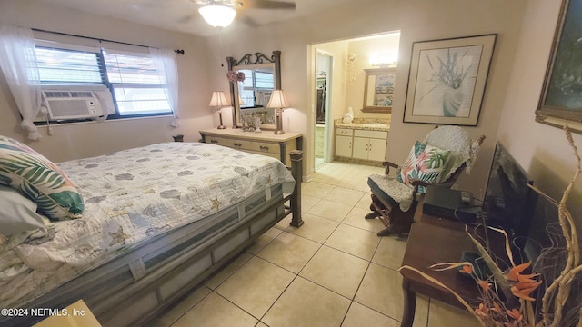 bedroom featuring cooling unit, ensuite bathroom, light tile patterned flooring, and ceiling fan